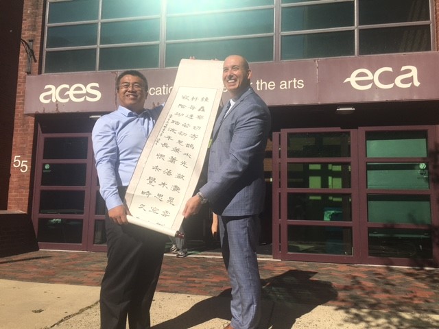 Qindao No. 2 High School delegate  and ACES ECA Principal Jason Hiruo with Chinese Scroll