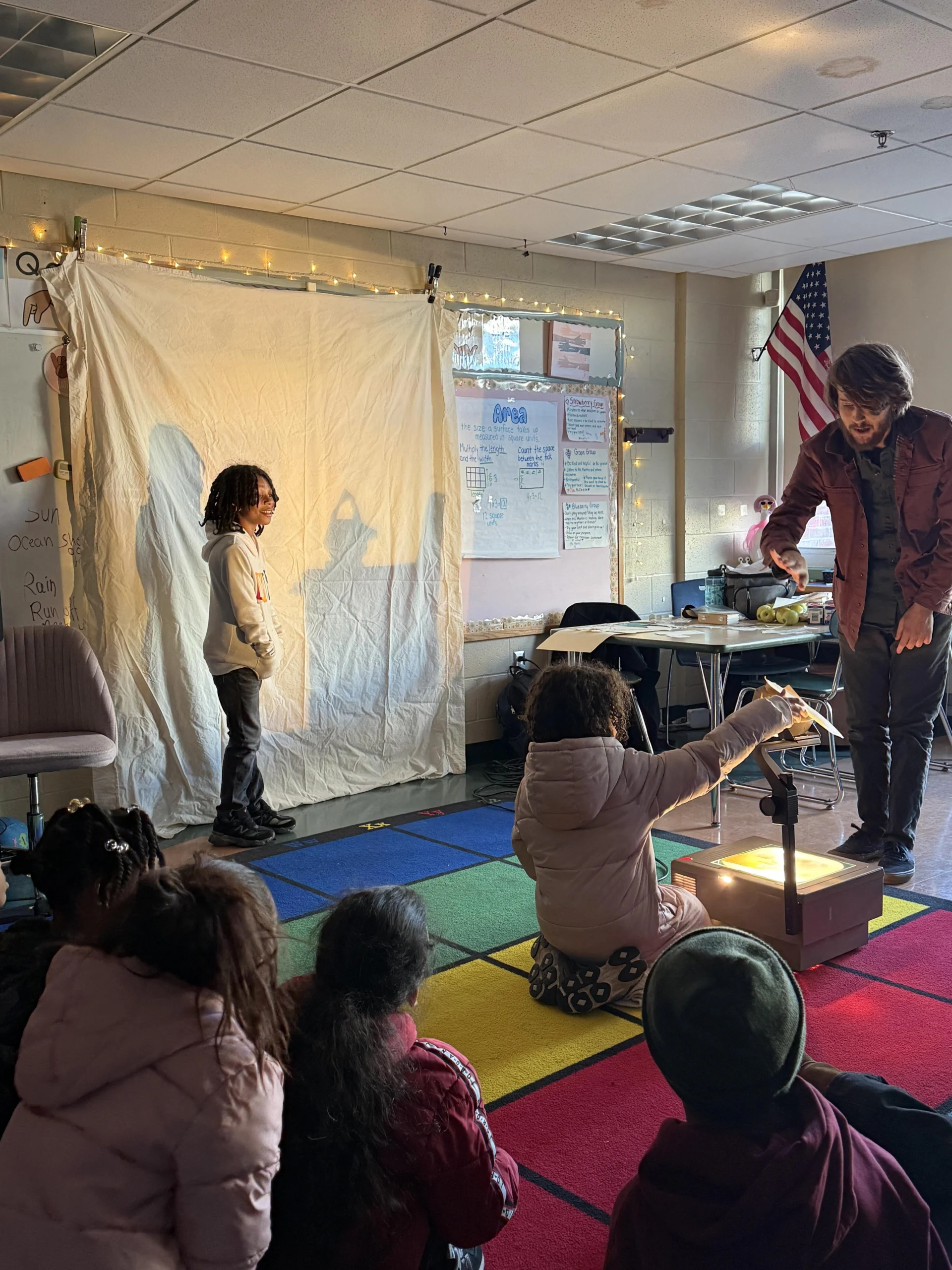 students and teacher using a projector in classroom