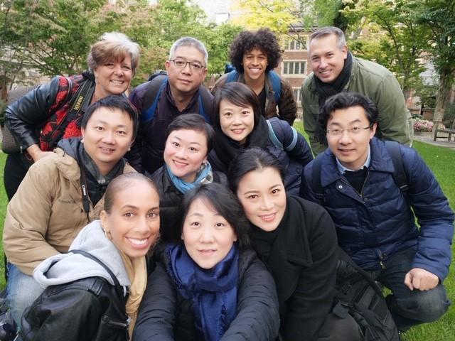 "The Visiting Scholars team poses for a photo in a natural area.”