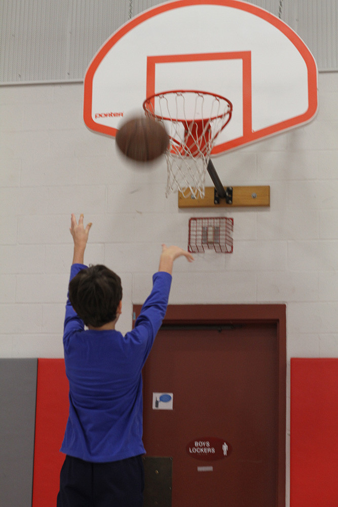 Student playing basketball.