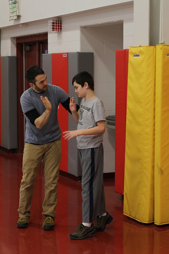 Teacher giving student a high five.