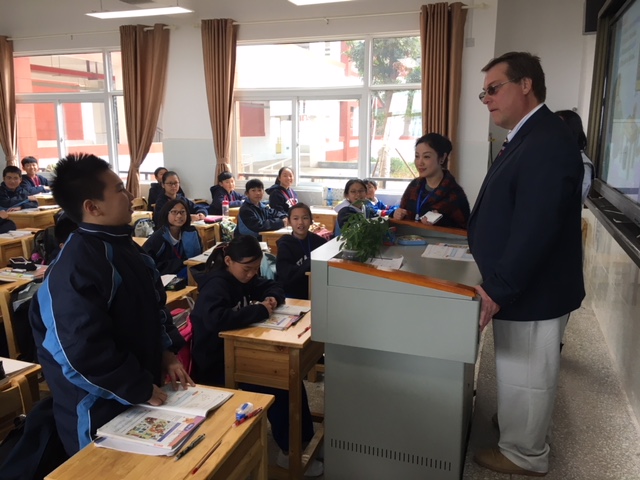 Tim Howes speaking with students in a Yali Middle School Class