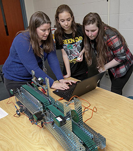 Students and teacher working in Automation Robotics class