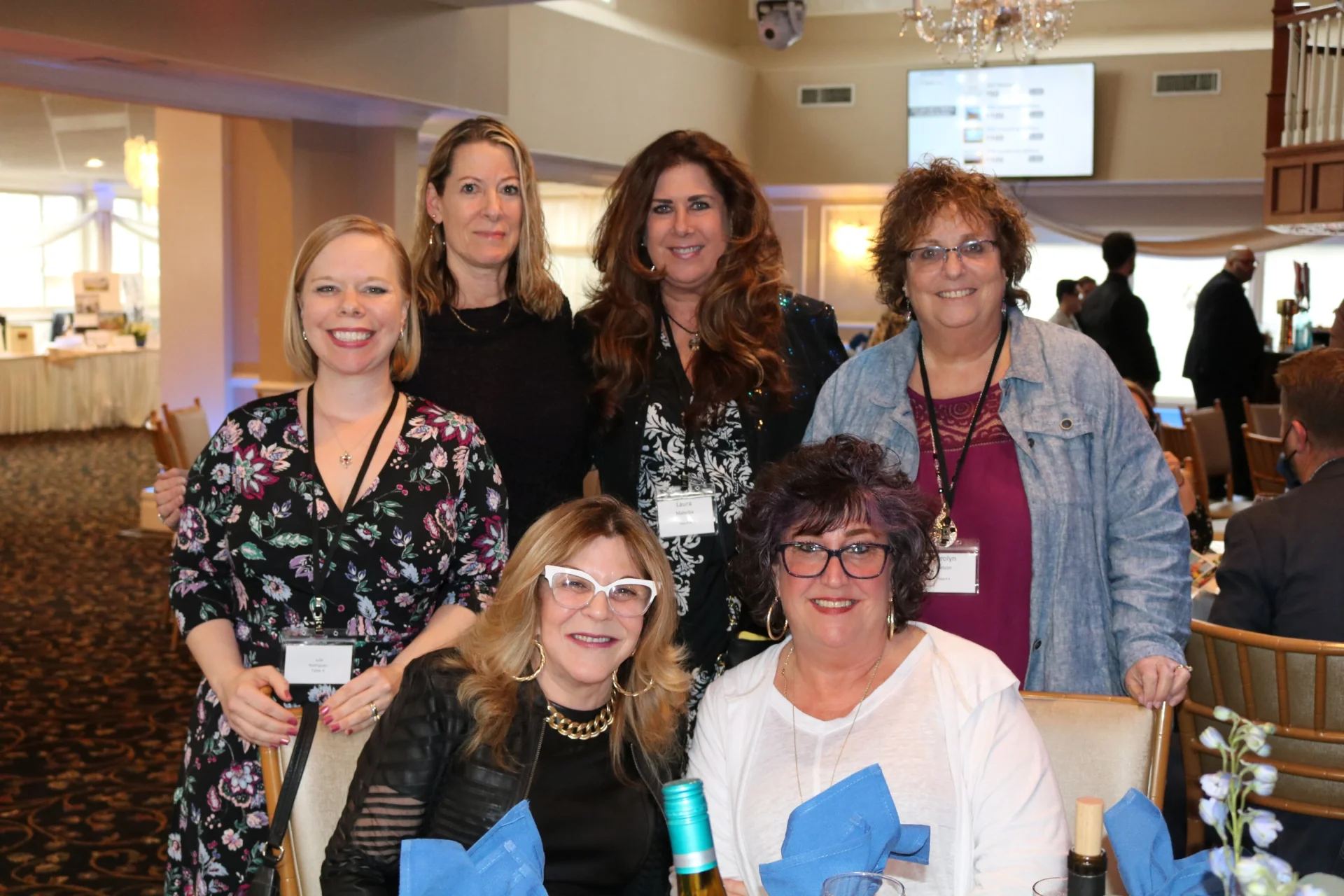 6 people at a gala table smiling