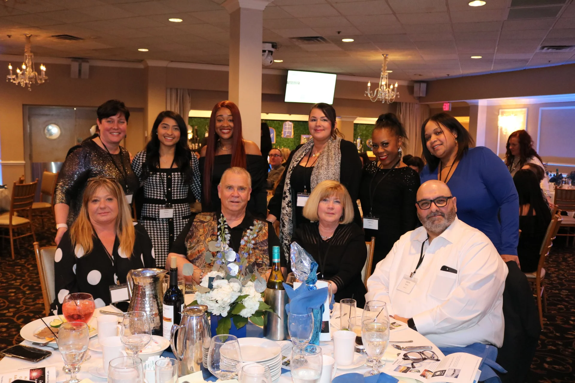large group of people agt a gala table smiling