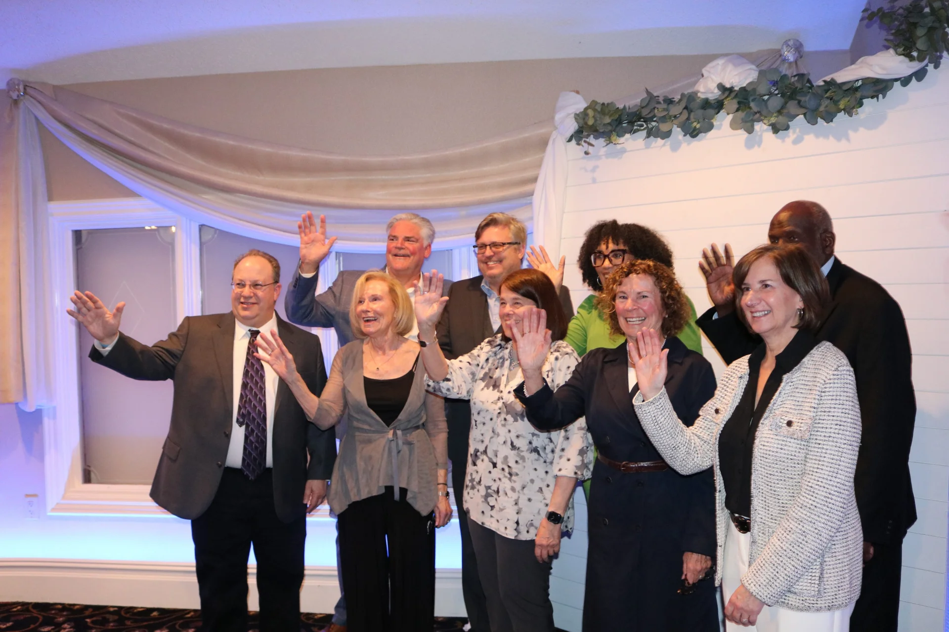group of people at gala waving
