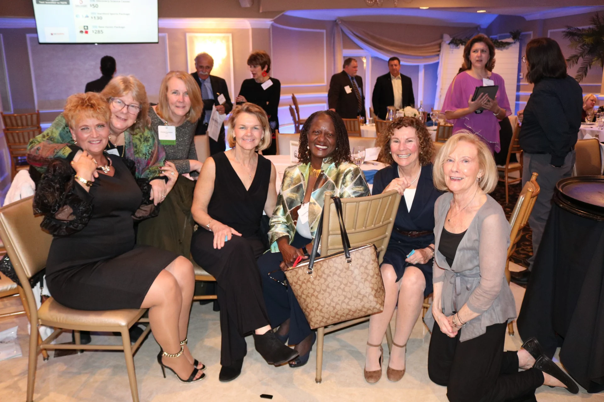 group of women smiling at a gala table