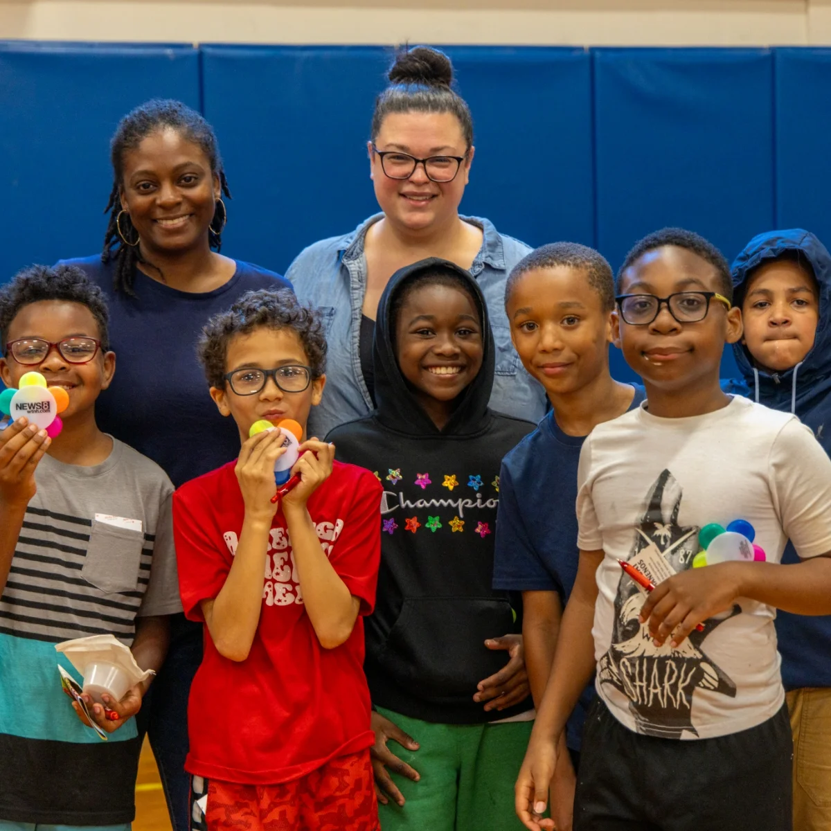 group of students and 2 teachers in a gymnasium