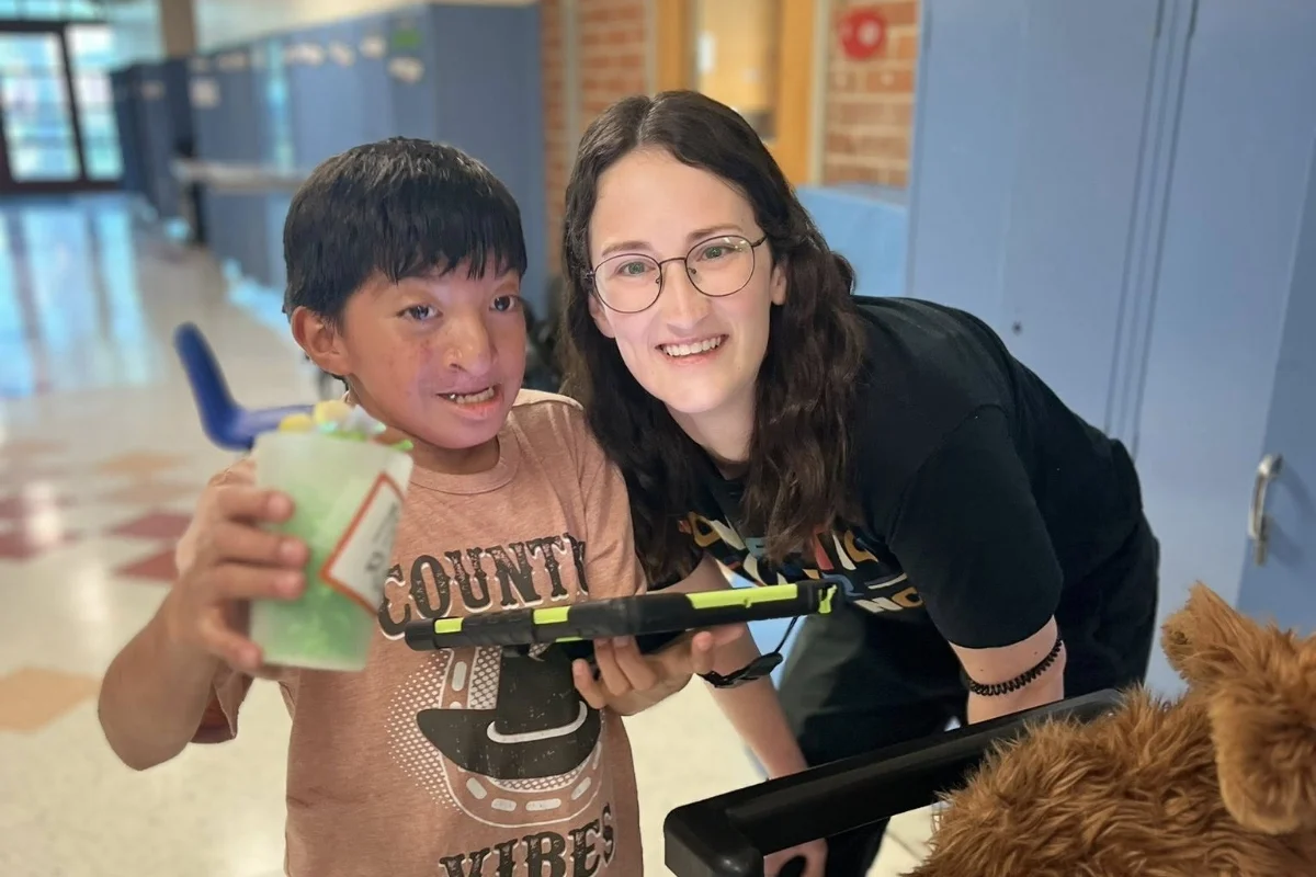 Village School student and teacher in hallway