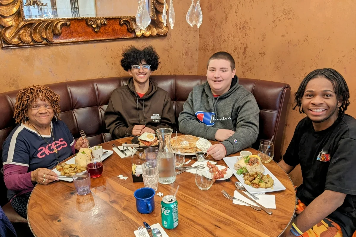 3 students and a teacher at a restaurant